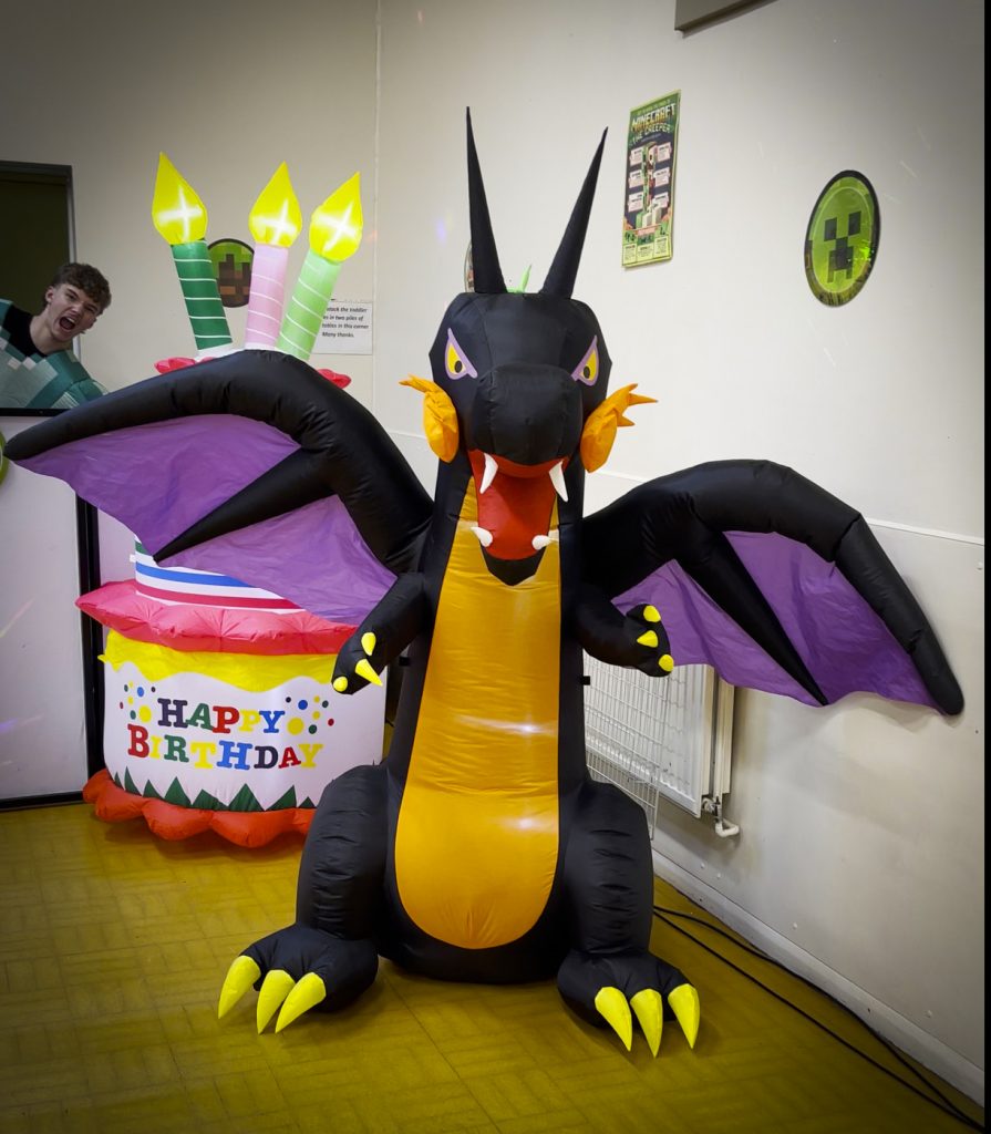 LED‑lit inflatable Ender Dragon decoration at a Minecraft party