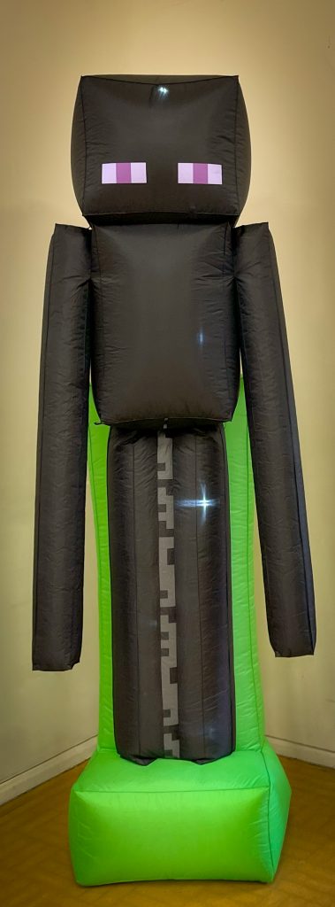 Our giant Enderman stands eight feet tall and glows during the second‑half disco, thrilling up to 40 young Minecrafters.