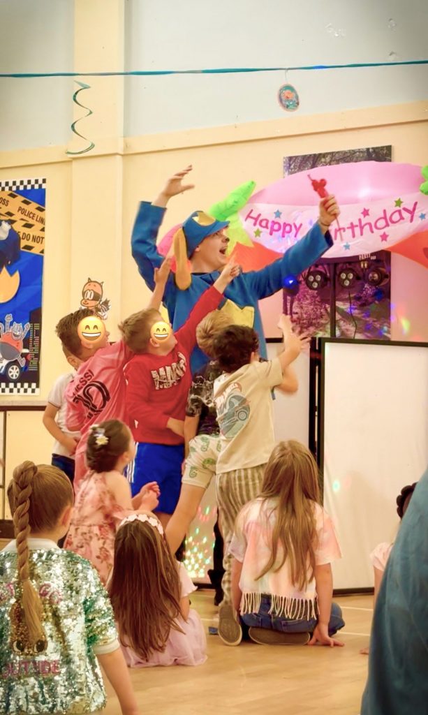 Dog Man birthday entertainer leading energetic games at children’s party near Woking