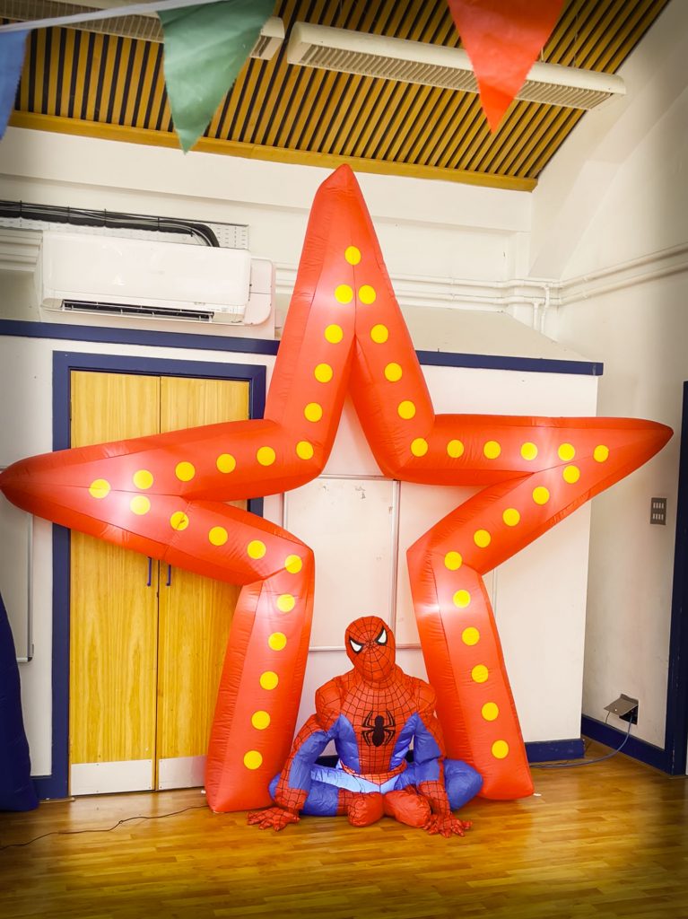 Giant star inflatable with Spider-Man inflatable creating a superhero party backdrop in Wokingham near Chobham and Fleet