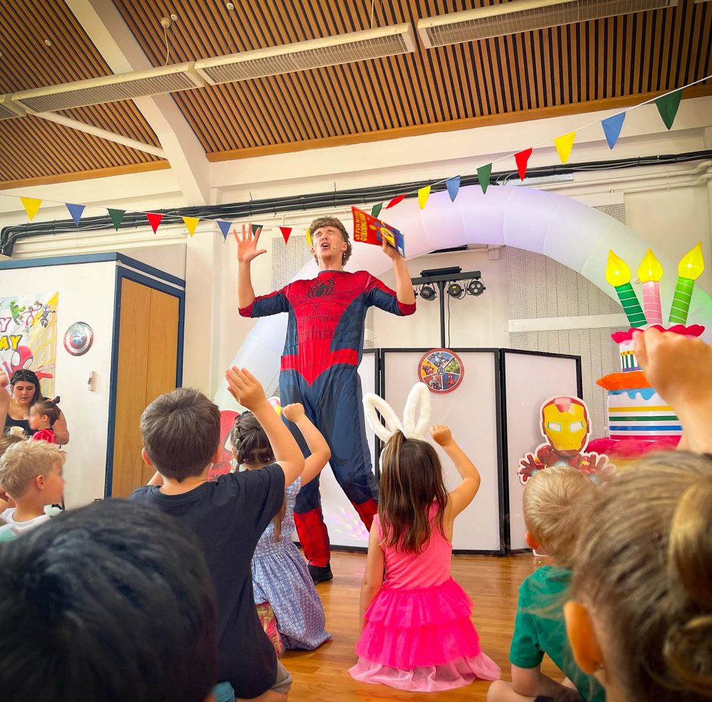 Superhero entertainer leading fun games at a children’s birthday party in Camberley near Farnborough and Fleet