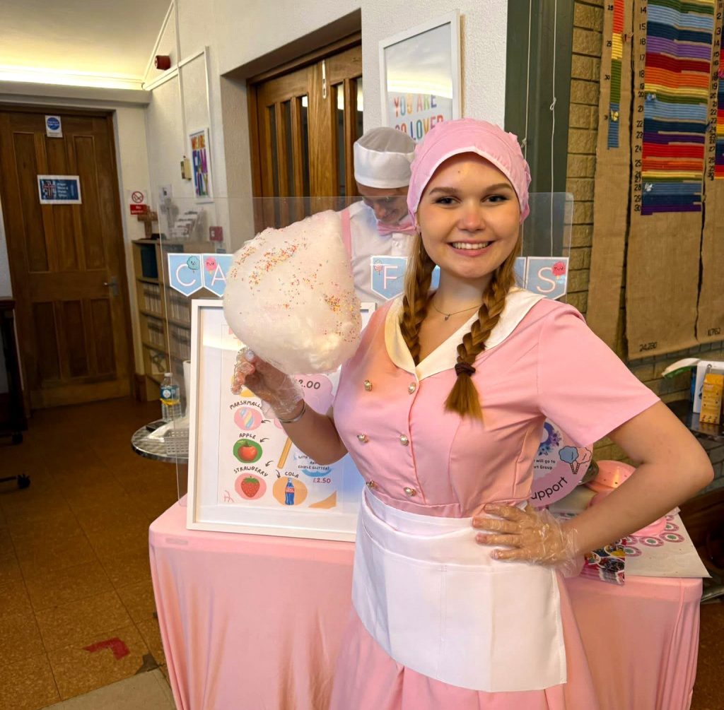Candy floss entertainer for children’s parties in Camberley and surrounding areas - Childrens Party Entertainers | Surrey Hampshire and Berkshire | Treasure Box Parties Candy floss entertainer serving fresh candy floss at a children’s party in Surrey