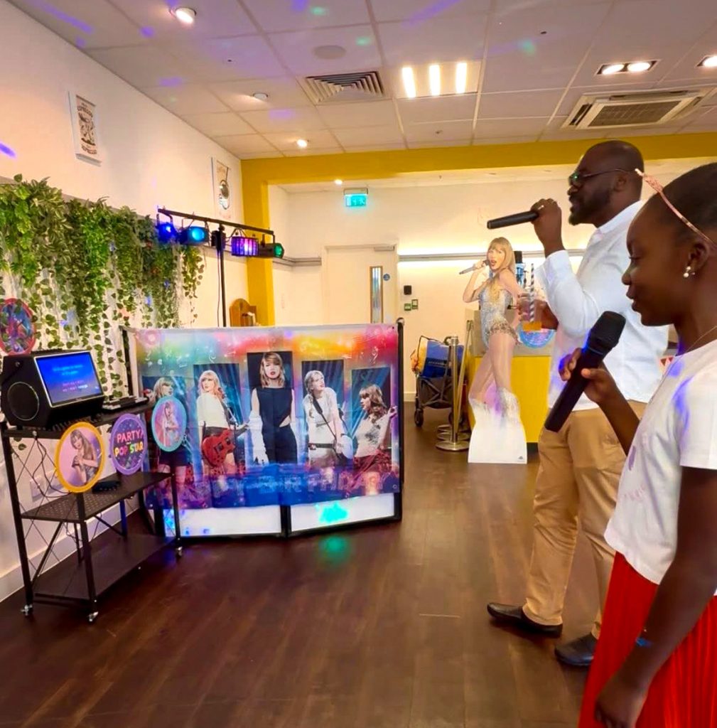 Karaoke party entertainment for children in Camberley and surrounding areas - Childrens Party Entertainers | Surrey Hampshire and Berkshire | Treasure Box Parties Karaoke machine setup at a family birthday party with children singing together in Surrey