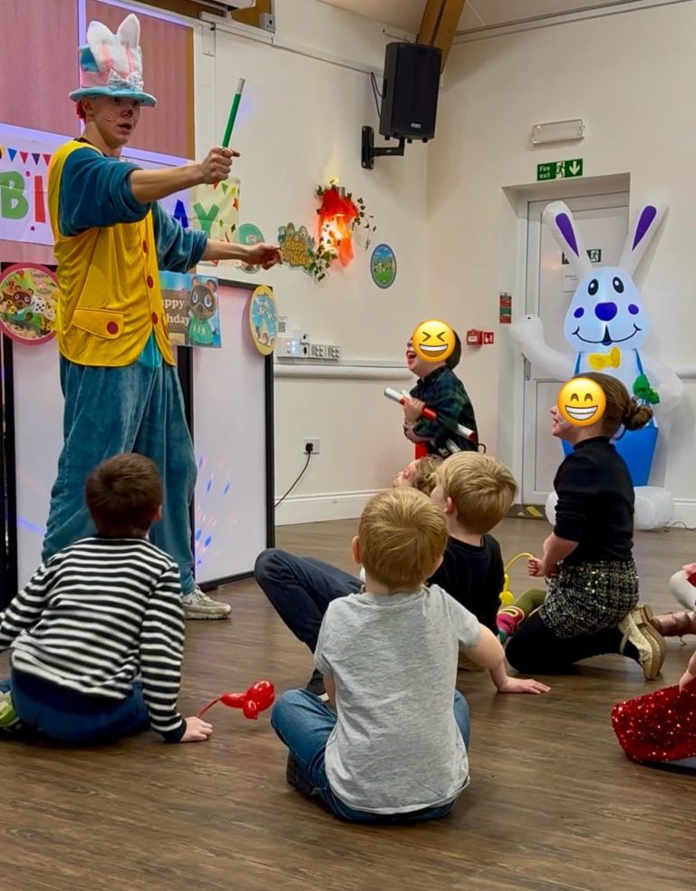 Entertainer performing magic for children at an Animal Crossing themed party