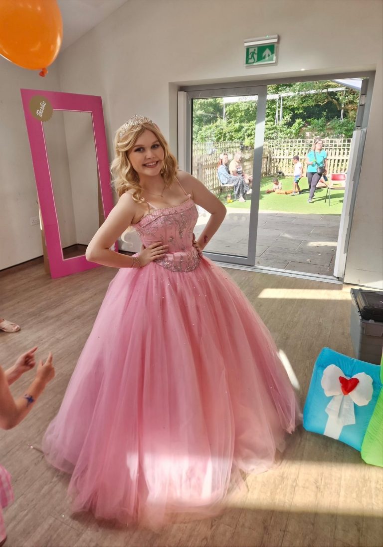 Barbie entertainer in a pink ball gown in a bright hall