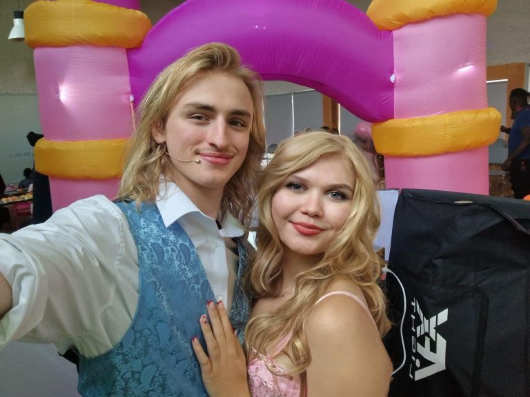 Barbie and Ken entertainers selfie under a pink castle arch