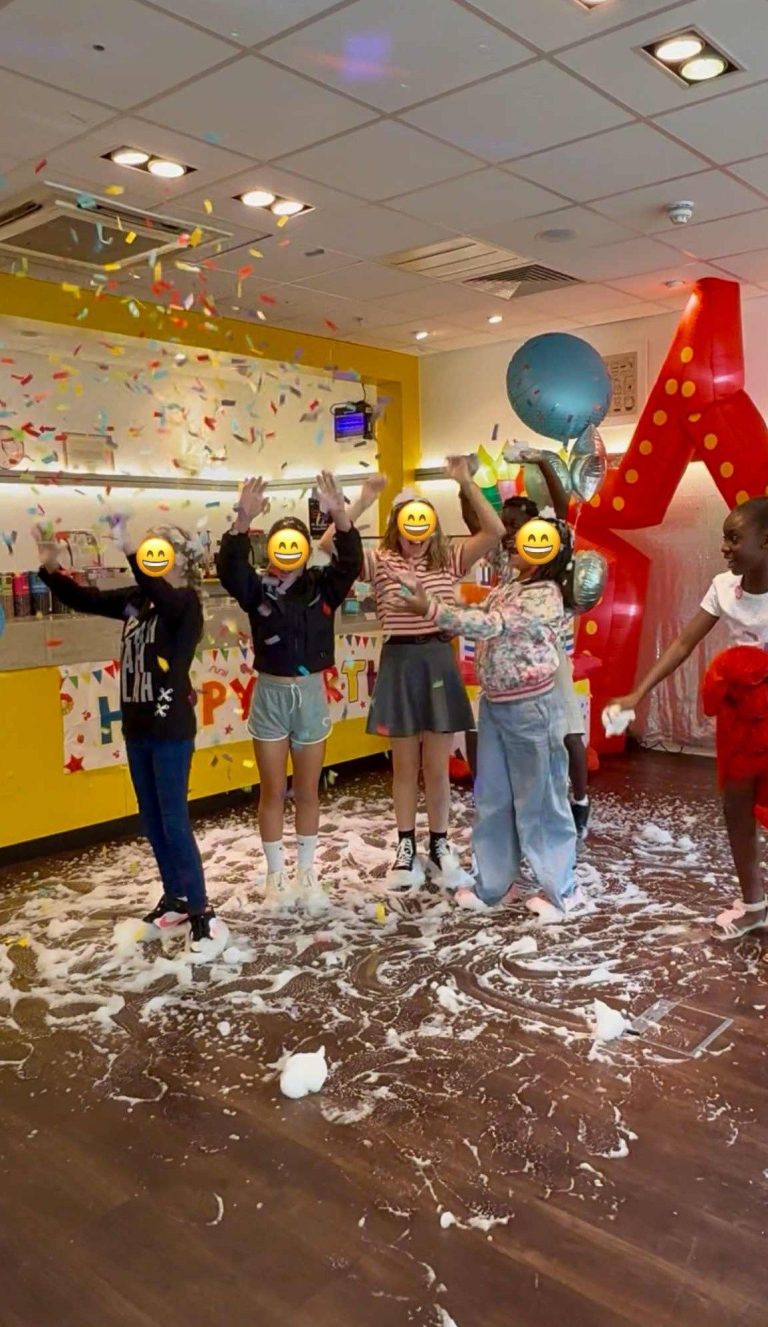 Children dancing in foam and confetti