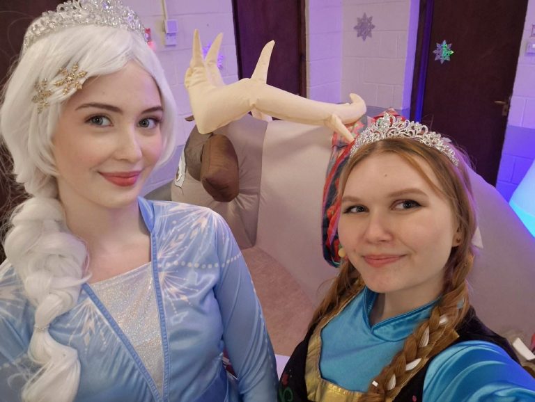 Close-up selfie of Elsa and Anna entertainers at a party