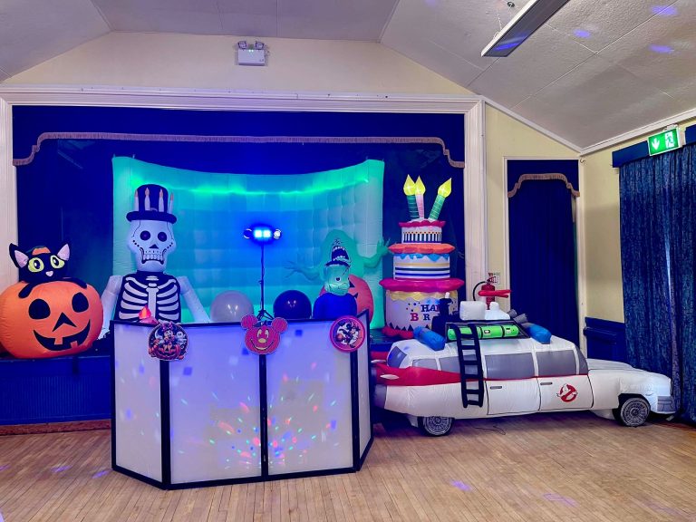 Halloween party setup with skeleton, pumpkin and ghost car inflatables