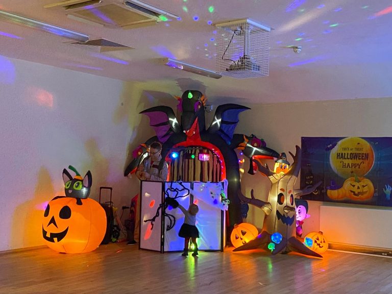 Halloween setup with pumpkins, spooky tree and witch inflatables