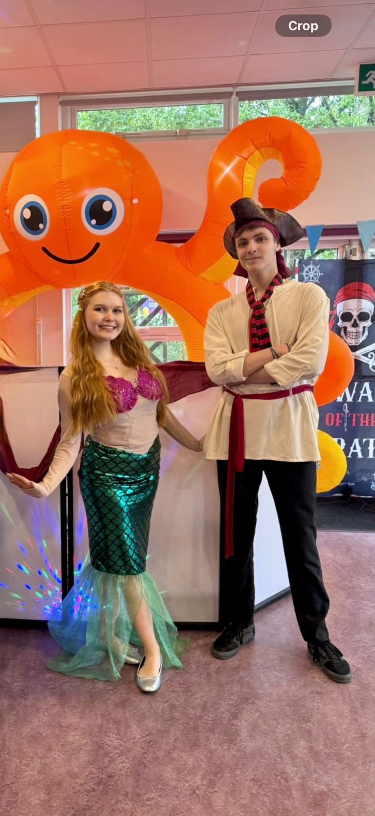Ariel and a pirate entertainer under a giant octopus inflatable
