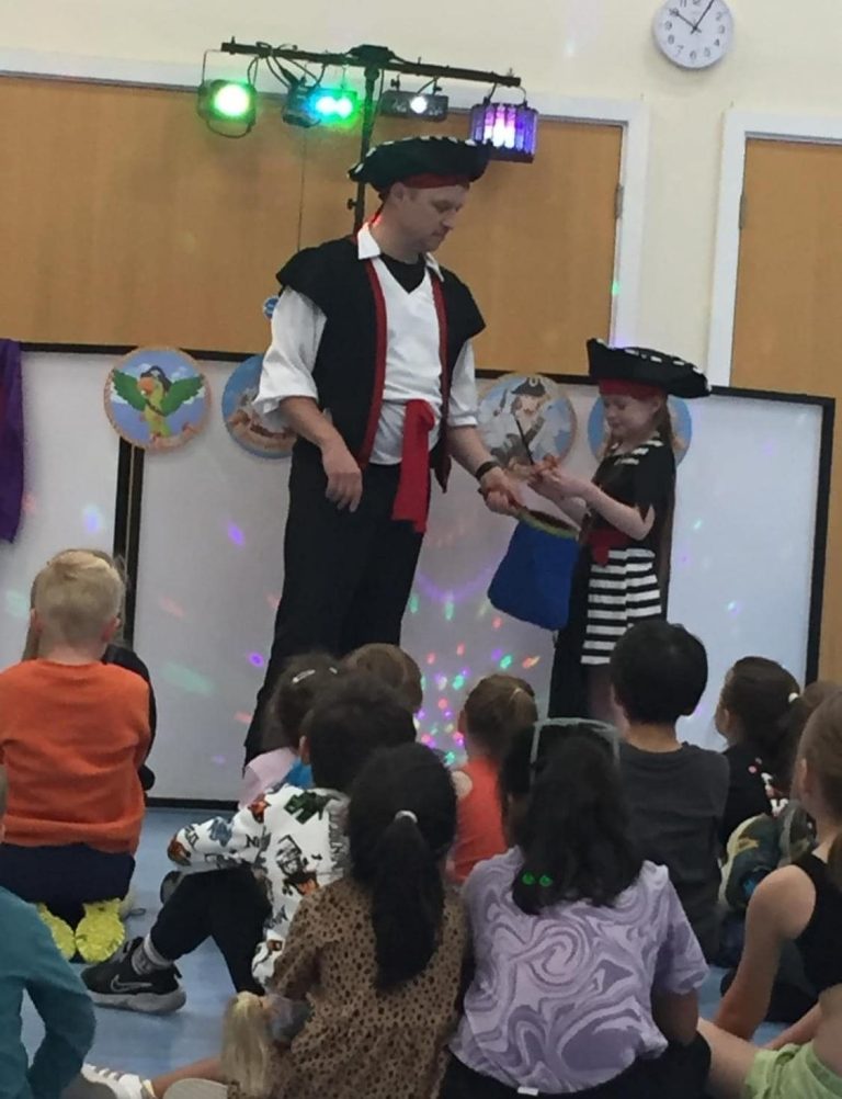 Pirate entertainer performing magic with a birthday boy
