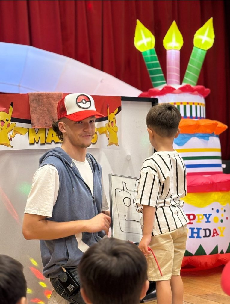 Pokémon trainer entertainer performing magic with a birthday boy