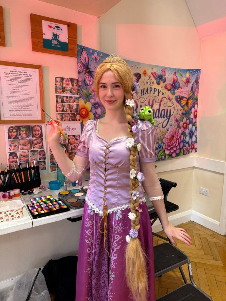 Rapunzel entertainer with long braided hair at a face painting station