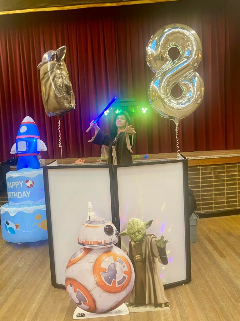 Star Wars decorations with BB-8 and Yoda figures beside the DJ booth