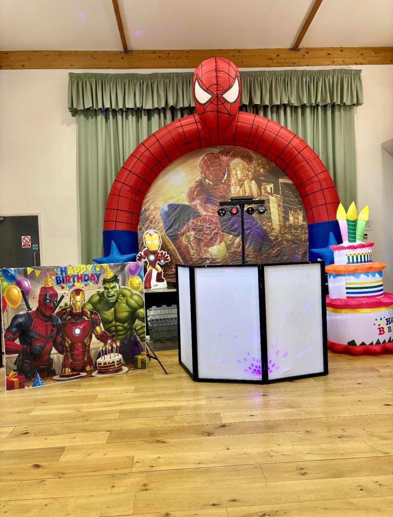 Spider-Man arch, superhero backdrop and birthday cake inflatable set up in a hall