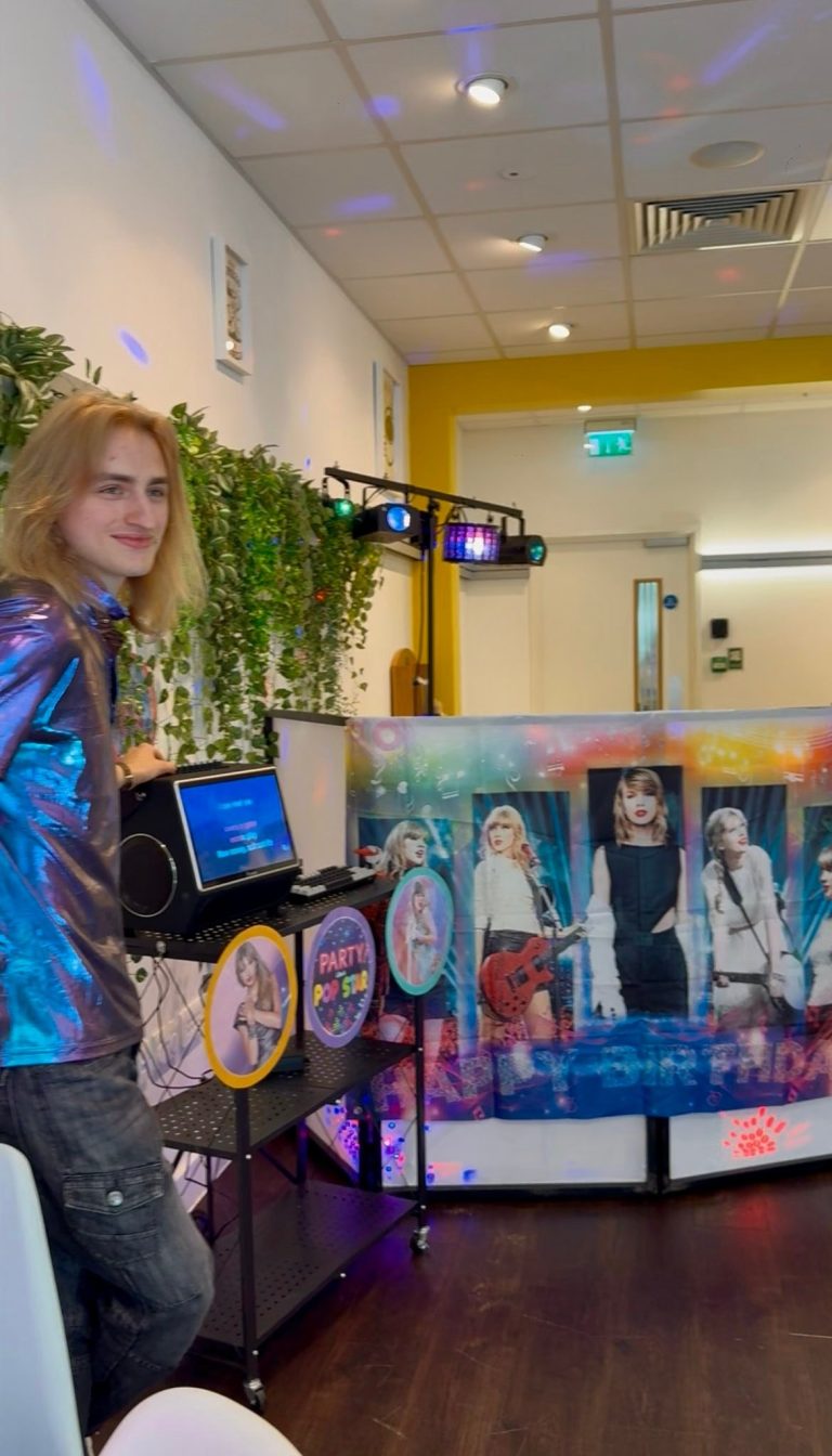 Karaoke setup with screen and pop star themed DJ booth