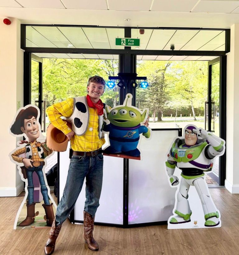 Woody entertainer at the DJ booth with Buzz Lightyear and alien cut-outs