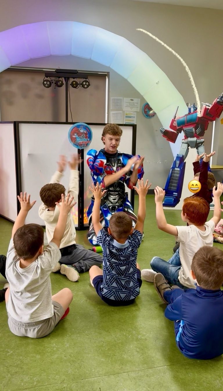 Optimus Prime entertainer leading a game with seated children